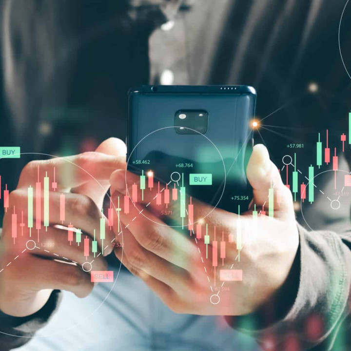 Businessmen work with stock market investments using smartphones to analyze trading data. smartphone with stock exchange graph on screen. Financial stock market.