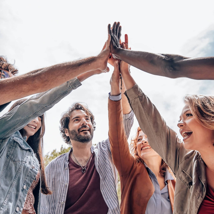 young people giving high five - group of diverse multiethnic people make unity - collaboration team success concept.